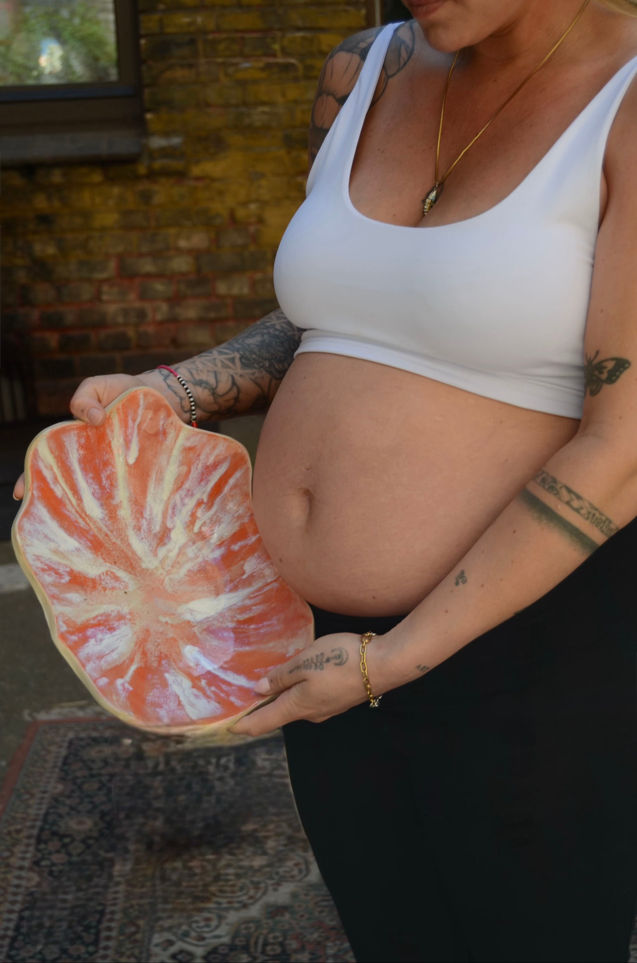 Expecting mother holding her finished belly bowl